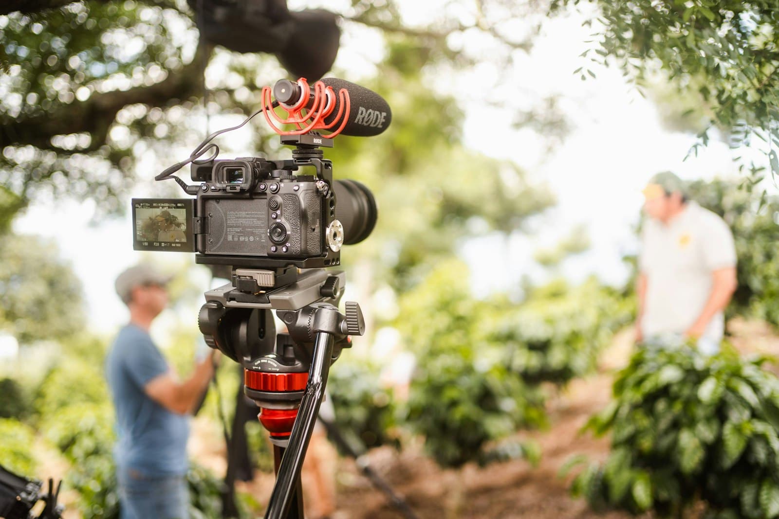 A camera on a tripod, set up to film a video